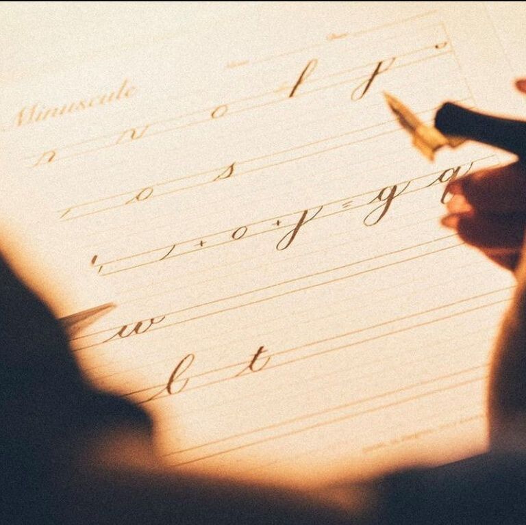Elegant copperplate calligraphy script on cream paper